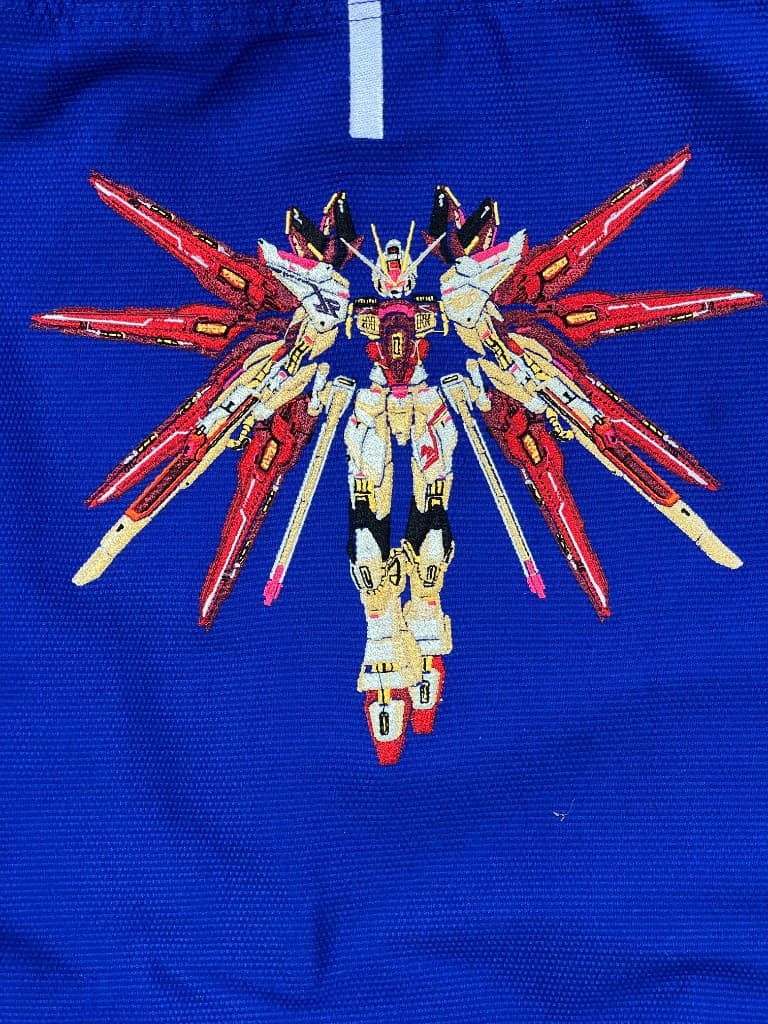 Intricate multi-colour mecha embroidery on royal blue pique fabric.